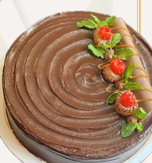 Couverture Truffle — chocolate ganache cake with a swirled finish, cherries and mint